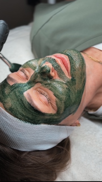 female face with green gel on face for facial